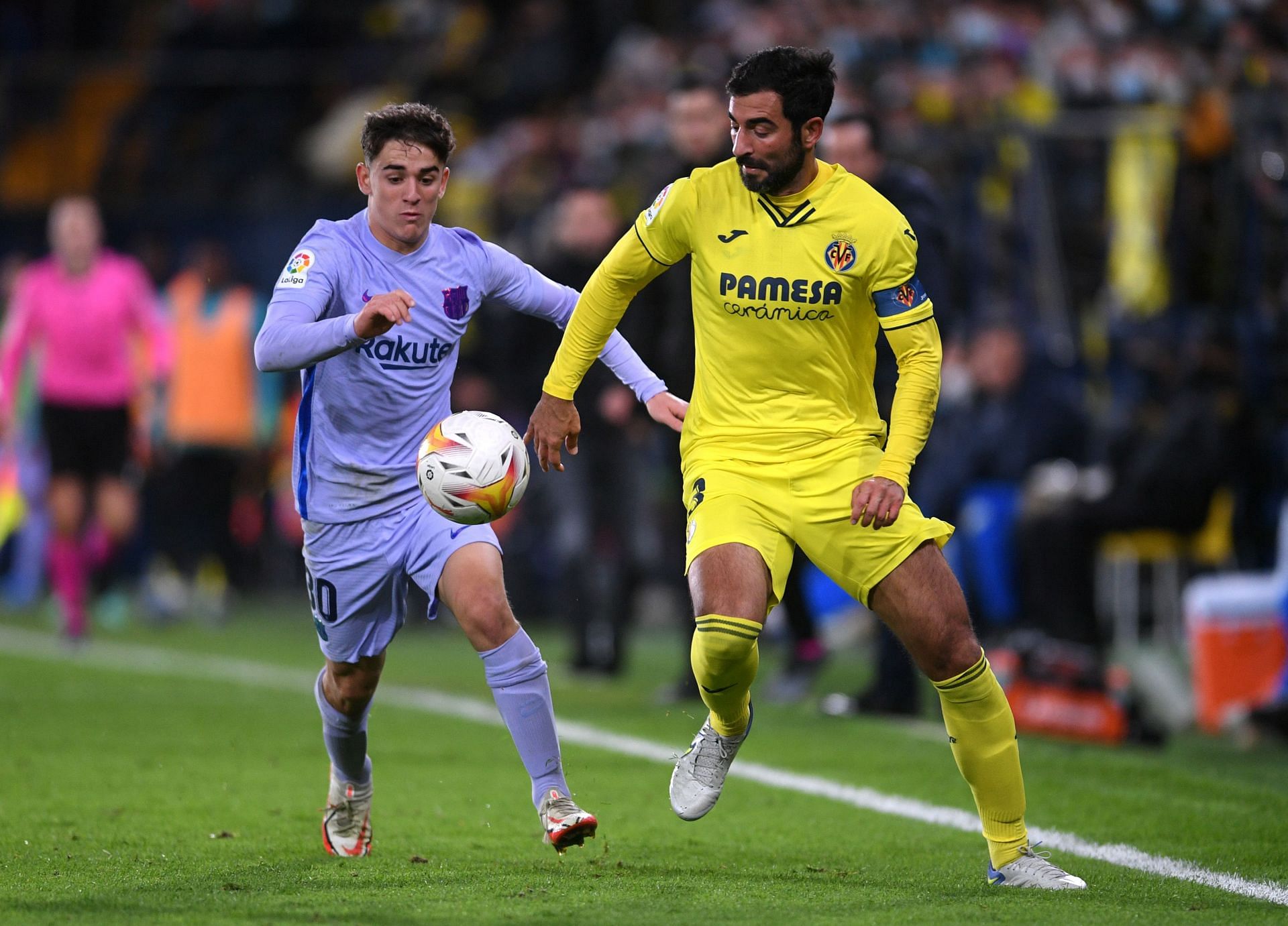 Barcelona's Gavi (L) challenges Raul Albiol of Villarreal (R)